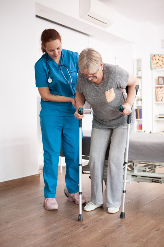 Nurse assisting elderly patient walking with support at home – MedinGlobal home care services